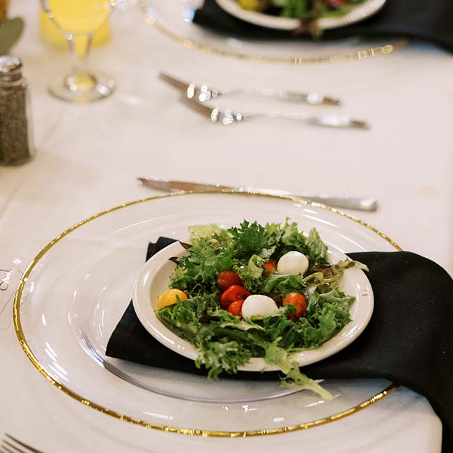 Small salad with cherry tomatoes and mozzarella, perfect for a Rustique Barn wedding catering.