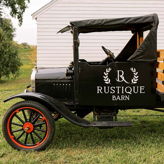 Vintage black truck with Rustique Barn logo, perfect for catering your wedding ceremony on the lawn.